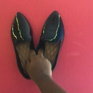 Black flat pointed dress shoe.